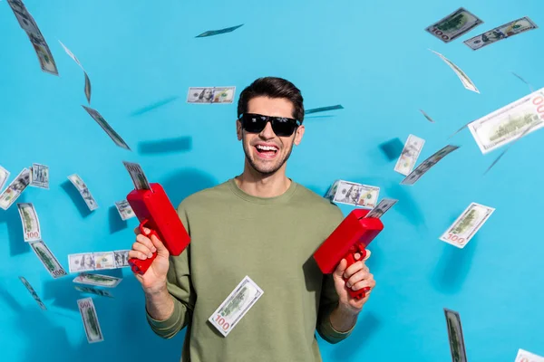 Photo of cool brunet young guy shoot money yell wear glasses grey shirt isolated on blue color background — Stock Photo, Image