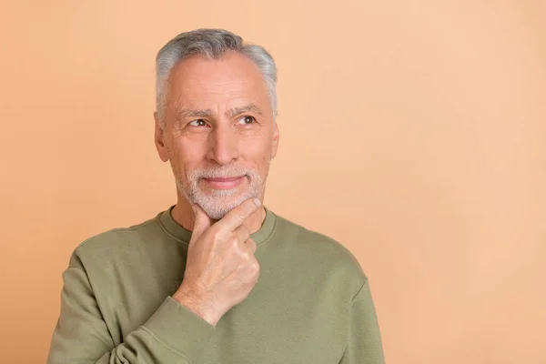 Photo of senior man hand touch chin wonder think look empty space isolated over beige color background — Stock Photo, Image