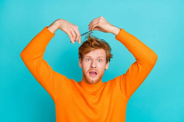 Foto av chockad rolig ung man bära orange pullover klippa hår isolerad teal färg bakgrund — Stockfoto