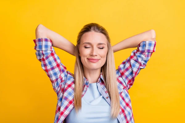 Photo of cute blond mature lady sleep wear plaid shirt isolated on yellow color background.