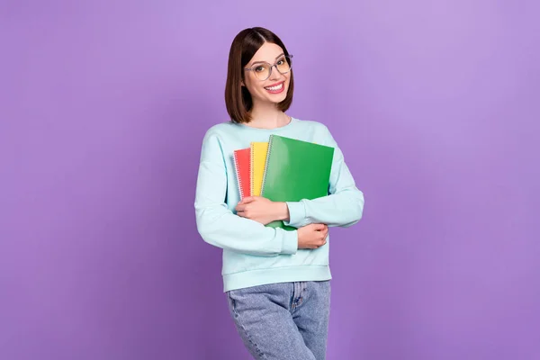 Photo portrait girl keeping book wearing glasses going to library isolated pastel purple color background.