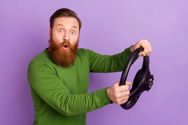 Photo of impressed confused person hold wheel drive new card pouted lips isolated on violet color background.