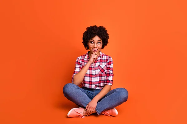Full body photo of minded intelligent lady hand touch chin look empty space isolated on orange color background.