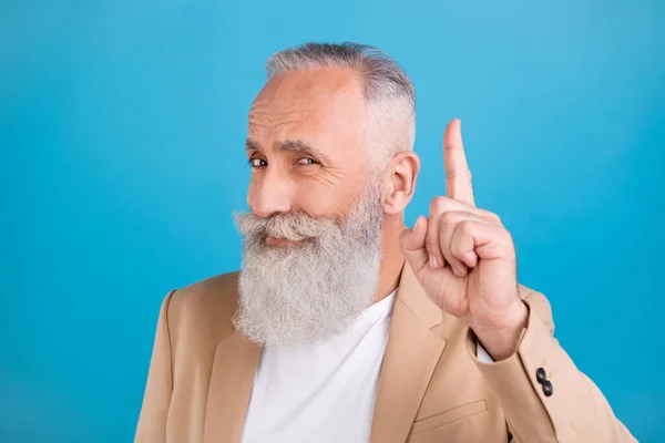 Portrait of handsome cheery smart clever grey-haired man pointing forefinger up good decision isolated over bright blue color background.