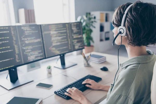 Profile side view portrait of attractive skilled girl expert answering calls coding cyber database at work place station indoors.