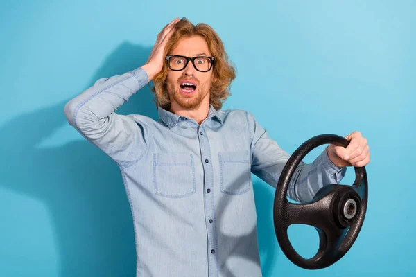 Photo of puzzled confused person hand touch head hold wheel stare speechless isolated on blue color background.