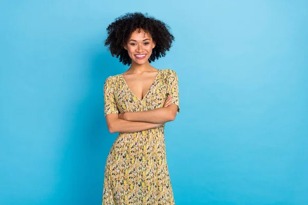 Photo of satisfied friendly person crossed arms beaming smile isolated on blue color background.