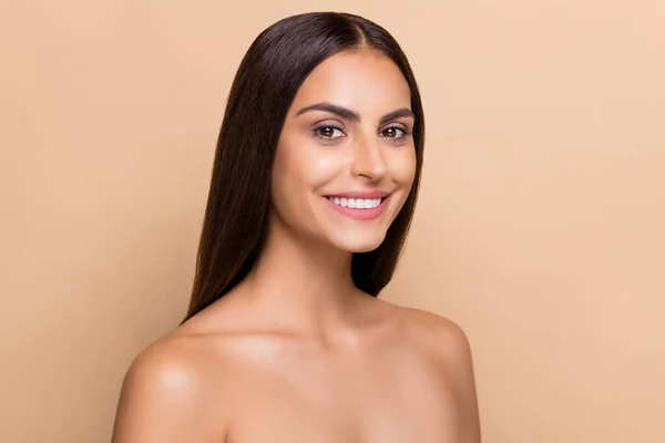 Portrait of attractive cheery perfect girl facial solution flawless smooth shine skin isolated over beige pastel color background.