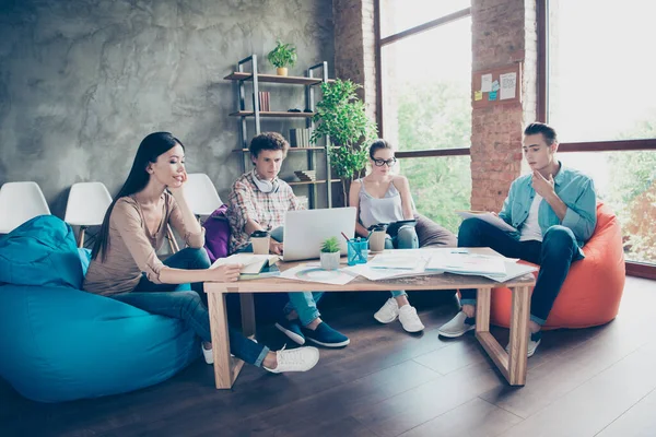 Full size photo of group intelligent people sitting beanbag studying prepare exam loft office indoors.