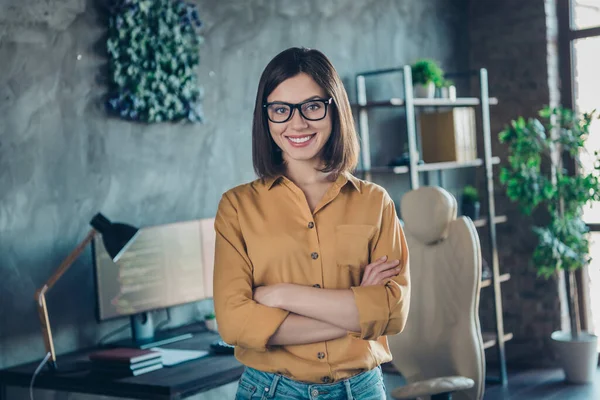 Portrait of attractive cheerful skilled successful girl agent broker company director folded arms at workplace workstation indoors.