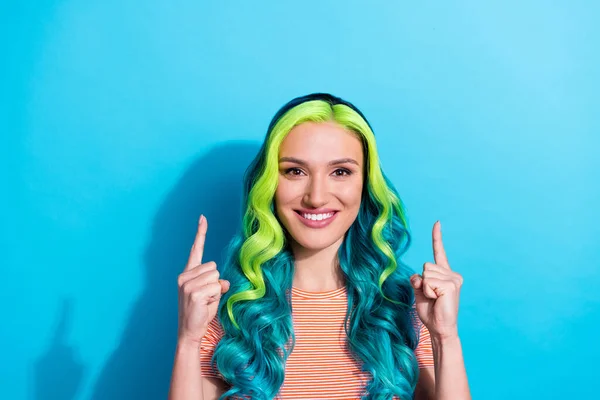 Photo of young pretty girl with aquamarine hair color point fingers up recommend new online shop isolated on blue color background.