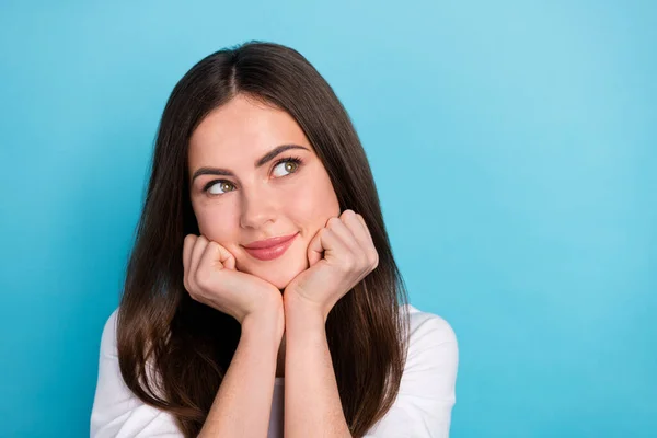 Photo of cute dreamy gorgeous lady look empty space daydreaming enjoy weekend isolated on blue color background.