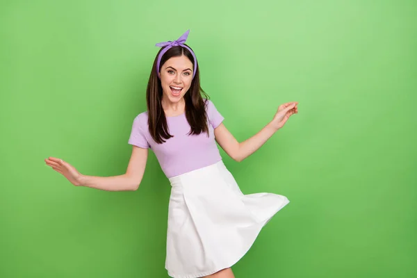 Photo of hooray brunette lady dance wear purple t-shirt band skirt isolated on green color background.