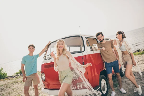 Photo of four carefree buddies bohemian dream vacation voyage wear casual outfit nature seaside beach.