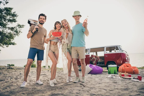 Photo of 70s style best buddies celebrate summer gathering wear boho outfit nature seaside beach outside.