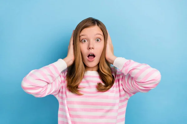 Portrait of shocked confused person hands head cover eyes open mouth isolated on blue color background.