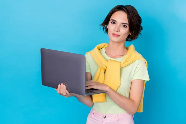 Photo of dreamy sweet woman wear green t-shirt typing modern device isolated blue color background.