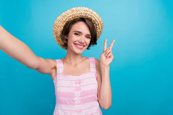 Photo of cool young funky lady do selfie wear sunhat pink dress isolated on blue color background.