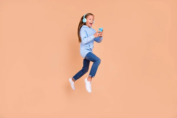 Full Length Photo Beautiful Excited Schoolgirl Run Jump Use Phone — Zdjęcie stockowe