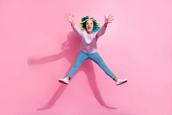 Full length photo of active satisfied person falling jumping raise opened hands isolated on pink color background.