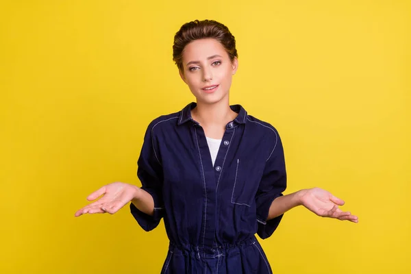 Photo of young pretty good looking positive girl shrug shoulders clueless oops sorry isolated yellow color background.