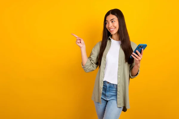 소녀가 온라인 쇼핑을 노란색 배경에 고립된 핸드폰을 사용하여 온라인 쇼핑을 — 스톡 사진