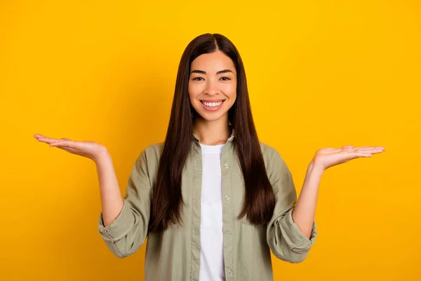 Photo Young Good Mood Female Compare Two Different Products Objects — Stock Fotó