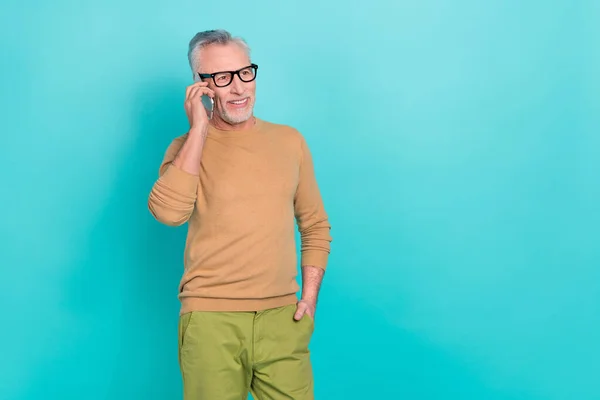 Photo of positive friendly person speak communicate telephone isolated on turquoise color background.