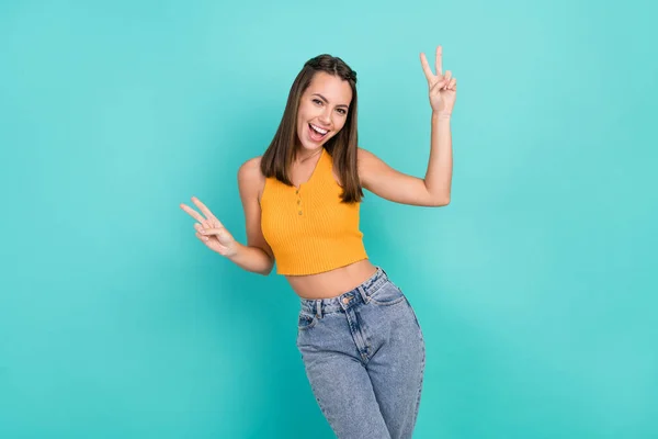 Photo of cheerful happy nice young woman make fingers two v-signs smile enjoy isolated on teal color background.