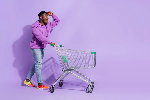 Full body profile photo of excited astonished man hand forehead look empty space isolated on purple color background.