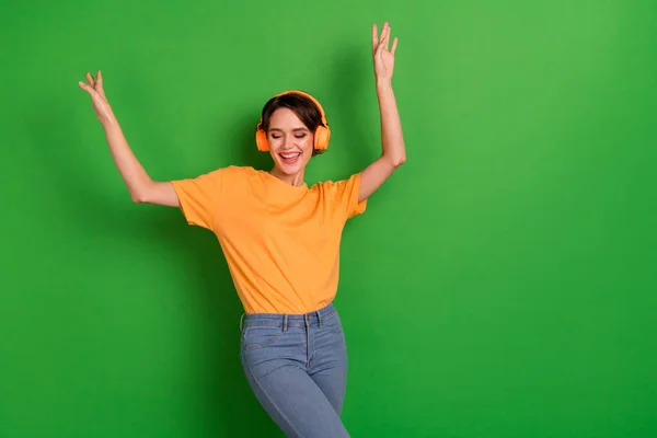 Photo of crazy carefree girl have fun dancing enjoy new single playlist isolated on green color background.