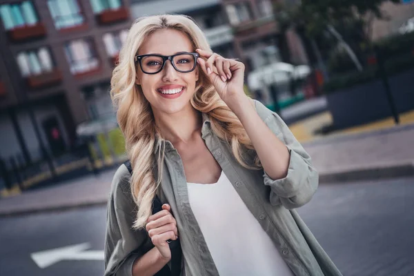 Photo of lovely satisfied person arm touch eyewear have good mood spend pastime walk outside.