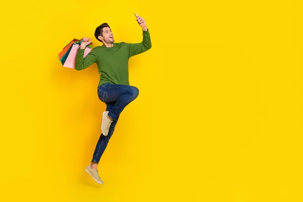 Foto Von Funky Funny Guy Dressed Green Pullover Jumping Holding — Stockfoto