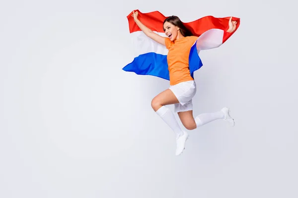 Champions Full body profile photo of funny lady jump up support soccer team game hold national netherlands flag, wear football t-shirt shorts cleats socks isolated white color background