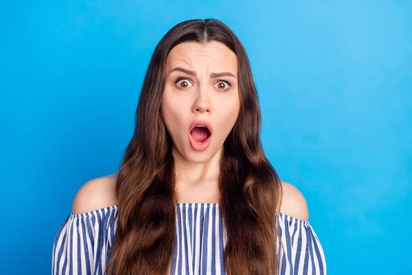 Photo of upset shocked young woman dressed striped outfit open mouth isolated blue color background.