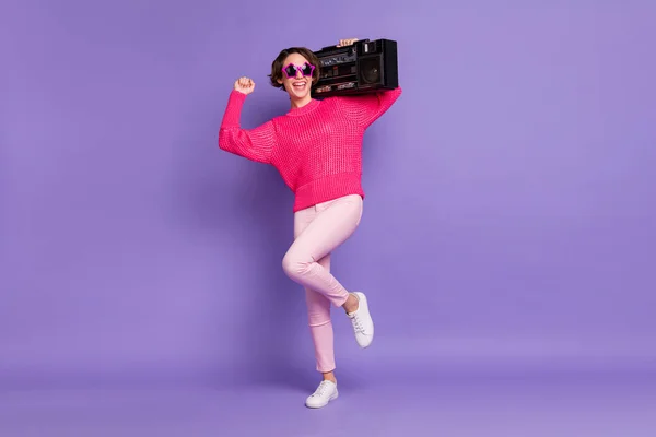 Full length photo of young hipster girl excited crazy dance party hold boombox isolated over violet color background.