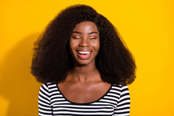 Photo portrait of young model laughing dreamy with closed eyes isolated on vivid yellow color background.