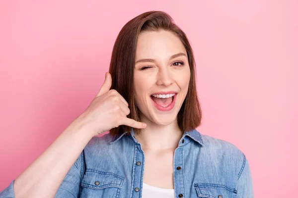 Photo portrait of girl smiling asking to call her winking blinking isolated pastel pink color background.