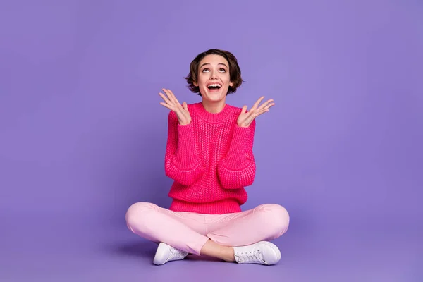 Full body photo of delighted person raise arms palms look up empty space isolated on violet color background.