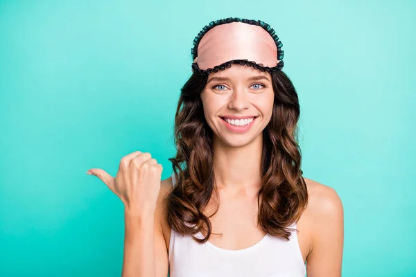 Photo of cheerful attractive person beaming smile direct thumb finger empty space isolated on teal color background.