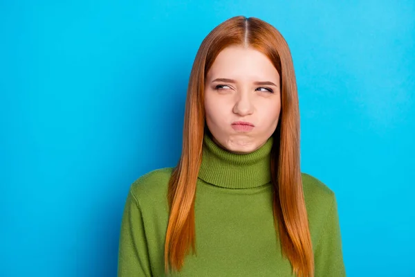 Photo of angry annoyed young woman red hair look empty space face isolated on pastel blue color background.