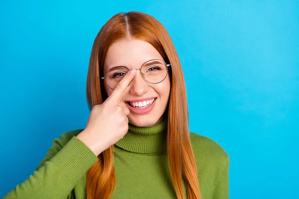 Photo of young satisfied person finger touch fix glasses have good mood isolated on blue color background.