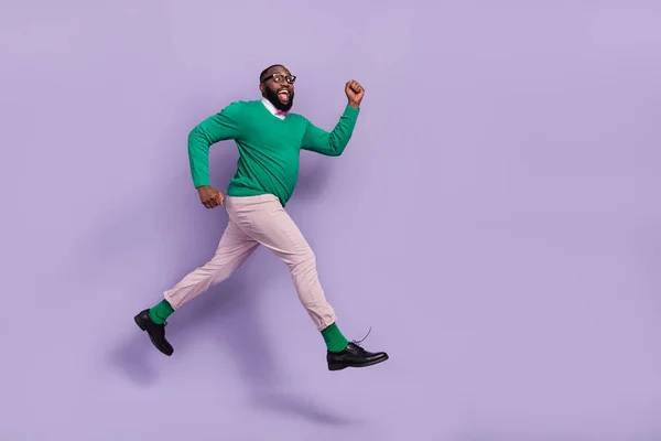 Full body profile side photo of running young man in hurry go on date with girlfriend isolated on purple color background.