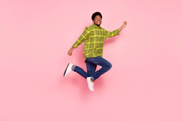 Full length photo of happy man jump up empty space amazed isolated on pink color background.