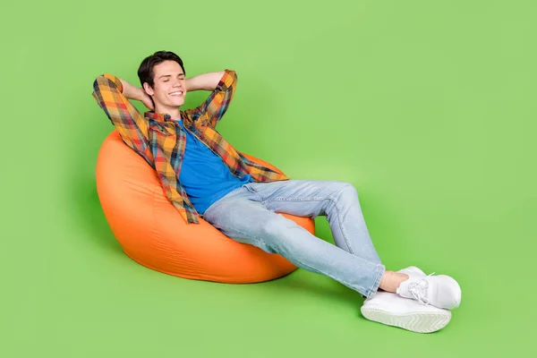 Photo Astonished Guy Sit Beanbag Relax Have Nap Wear Plaid — Stockfoto