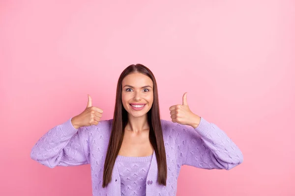 Photo of excited glad lady raise two thumb up toothy smile wear violet cardigan isolated pink color background.