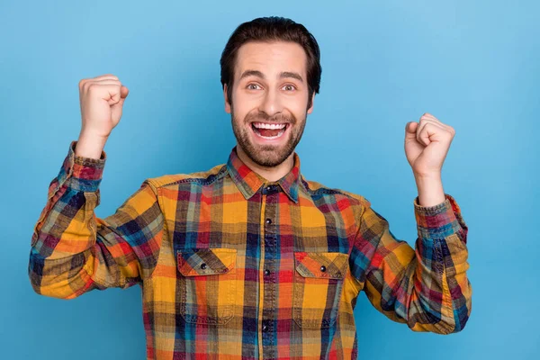 Photo Dreamy Excited Young Guy Dressed Checkered Shirt Rising Fists — Stockfoto