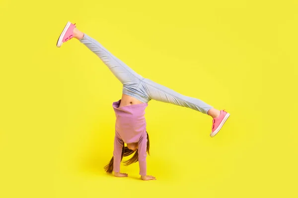 Photo School Child Stand Hands Doing Acrobat Practice Isolated Bright — Stock fotografie