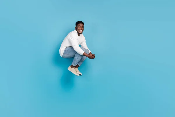 Full size photo of satisfied overjoyed person falling have good mood isolated on blue color background.