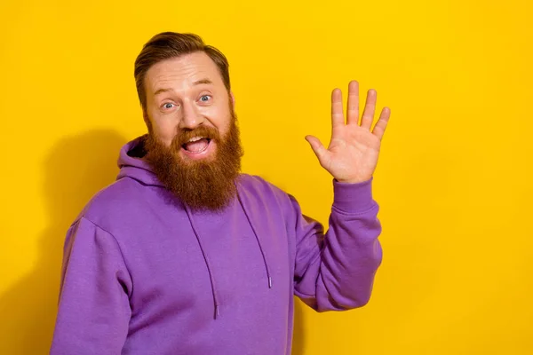 Photo of impressed satisfied person arm palm waving hello toothy smile isolated on yellow color background.